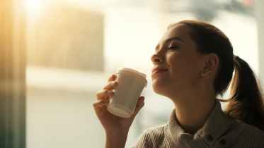 woman about to drink from plastic cup